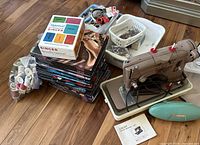 Overview of sewing machine, books, accessories, threads