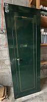 Front view of green Stack-On security cabinet showing full height and keyed door