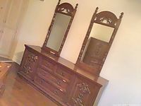 long dresser with two attached mirrors front view