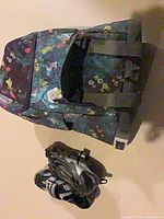 Pannier bag upright showing floral pattern and straps; cycling shoes positioned below