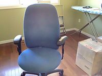 Front view of blue fabric office chair with armrests and caster base