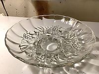 Top view of clear pressed glass serving bowl showing floral and fruit motif