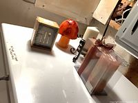 Lot overview showing mushroom candle, decorative box, metal holder with cream candle, packaged pair of pillar candles