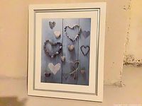 Front view showing heart artwork, mat and white frame