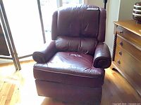 Front view of burgundy leather recliner showing overall style and condition