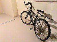 Full view of the Kona mountain bike showing frame, wheels, and accessories