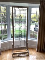 Full view of leaded glass panel on stand in bay window