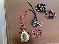 All four jewelry pieces laid out: two necklaces, two bracelets