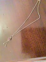 Full view of gold tone chain with amber stone