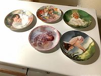 Front view of all five child-themed plates