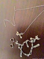 Necklace, bracelet, hoop earrings displayed