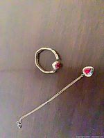 Necklace with heart pendant and stretch bracelet displayed flat showing overall design and stone placement