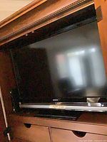 Front view of Sony television within cabinet