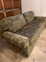 Sofa angled view showing rolled arm and skirt
