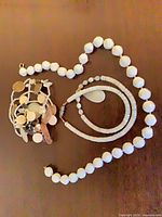All three jewelry pieces laid out showing bead styles and bracelet design
