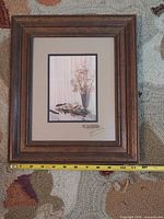 Front view of framed Art Gore floral print with tape measure indicating outer dimensions