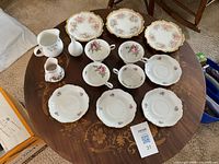 Top view of entire 12-piece porcelain tea service on table