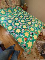 Full view of quilt on bed showing pattern and colors