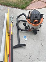 RIDGID vacuum with hose, nozzles, extension wands, yellow/red poles and aluminium channel sections