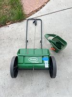 Scotts AccuGreen 1000 push spreader with HandyGreen II handheld spreader beside it