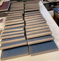 Top-down view of 40 blue-and-grey hardcover Yale Shakespeare volumes in two rows