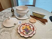 All items laid out: tureen set, Pistoulet bowl, Omnibus plate, butter mold, cadet figurine, wooden utensils