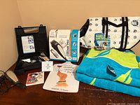 Overall lot showing clipper set, life jacket bag, Nautica towel, cutting board and coaster