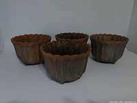Group view of four Bon Chef aluminum planters