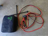 Overall view of bag, jumper cables, lug wrench