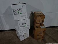 Stack of four white PPC PerfectLink cable boxes and two brown coax cable boxes