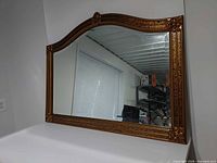 Full view of mirror showing arched top, frame style, and size context