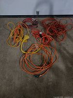 All five extension cords coiled on floor