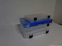 Three stacked compartment boxes showing size and color differences