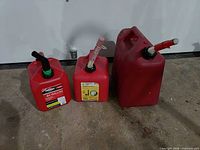 Front view of three red gasoline cans showing sizes and spouts