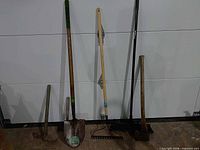 All five tools standing against wall