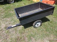 Full side view of black Agri-Fab dump cart on grass