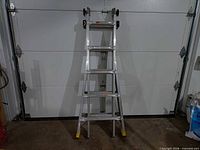Full view of Gorilla GLMPXA-22 ladder front against garage door