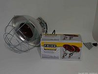 Fixture with installed red bulb beside boxed spare bulb