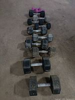 Row of six dumbbell pairs descending weight
