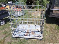 Full view of empty IBC tote cage outdoors