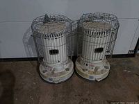 Two Dyna-Glo kerosene heaters side by side