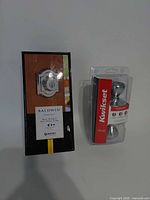 Retail boxed Baldwin deadbolt and blister-packed Kwikset knob set