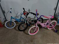 All three children’s bikes side by side in garage