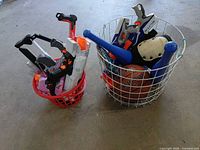 Both baskets showing Nerf blasters, basketball, toy bats and other items