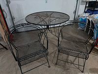 round metal mesh table with two matching chairs