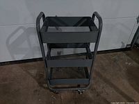 Front view of three-tier metal rolling shelf cart