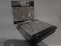 Stack of nine shrink-wrapped MSI La Crema Stax peel & stick mosaic tile packages