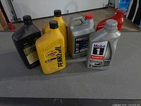 All six oil containers grouped on table