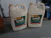 Front view of two Olympic Premium Deck Cleaner jugs