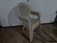 Front view showing three stacked beige plastic patio chairs